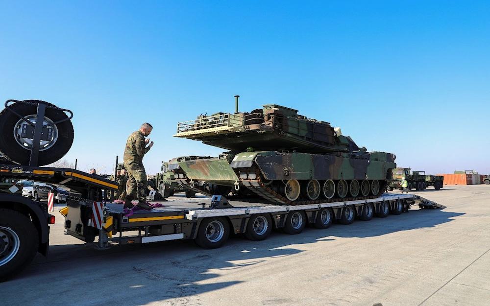 A military vehicle being loaded onto a flatbed trailer. Save On Transport: Efficient and cost-effective military vehicle transportation. #SaveOnTransport