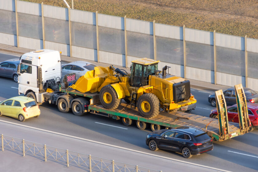 Truck with a long trailer platform for transporting heavy farm equipment