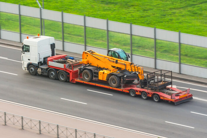 Truck with a trailer platform transports equipment with an elevator car platform, hydraulic and mechanical