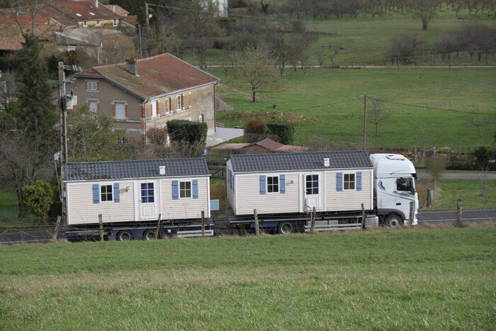 Two mobile homes on a truck while moving